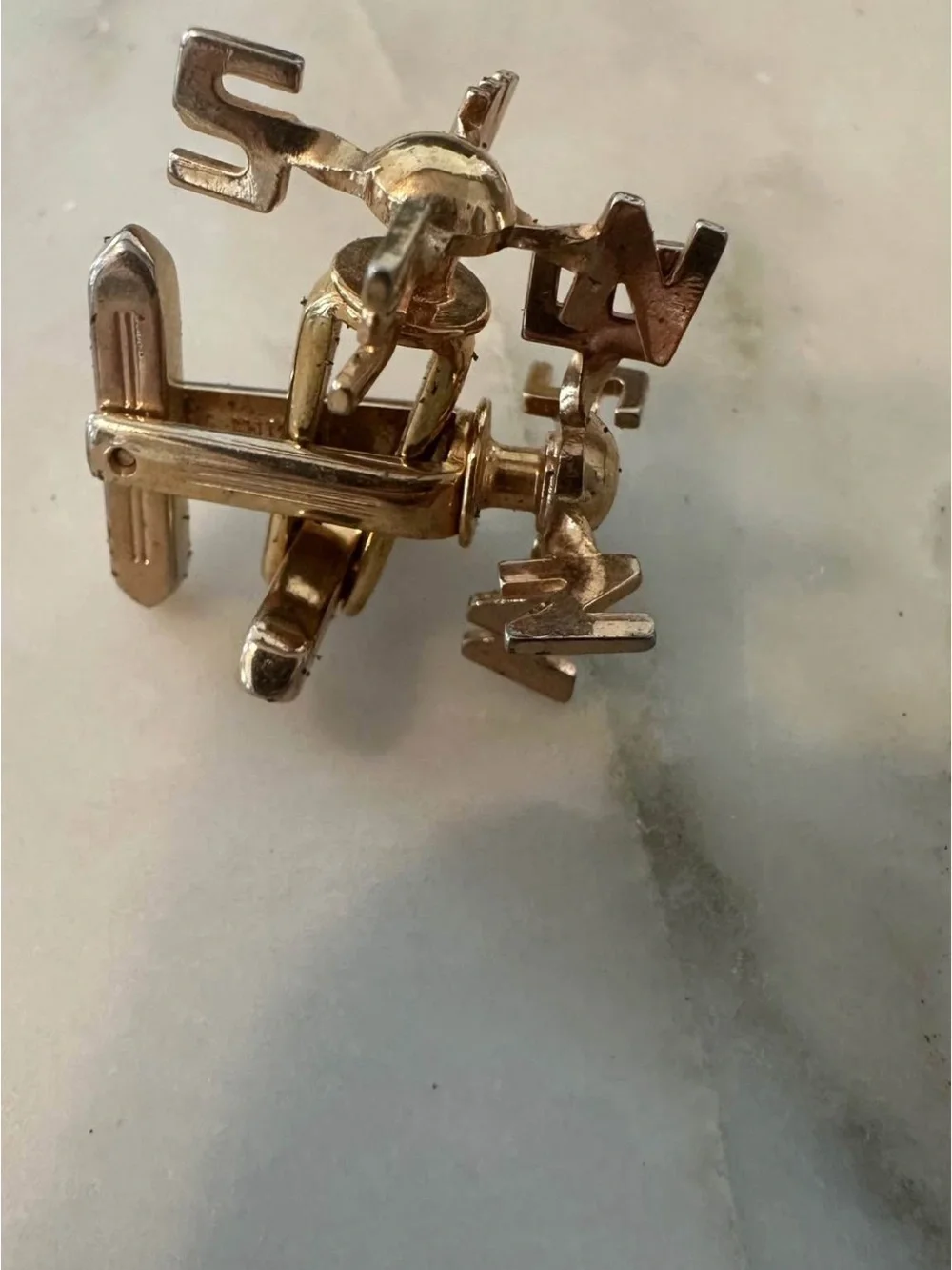 Gold-tone N  S E W cufflinks